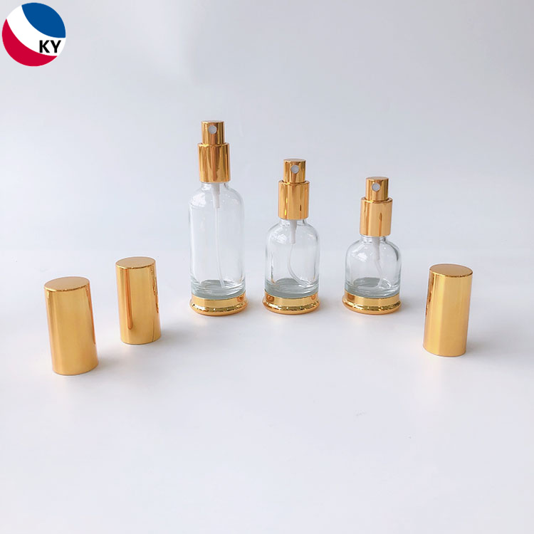 Luxury 15ml 30ml 50ml Round Gold Shoulder High Quality Clear Glass Pump Bottle with Gold Sprayer Pump